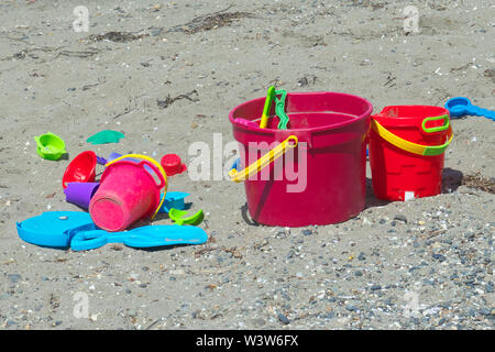 Children`s colourful plastic pails on the beach.  Crescent Beach, B. C., Canada Stock Photo